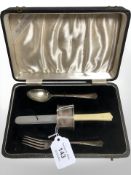 A silver fork, teaspoon and napkin ring, in fitted box with matching butter knife.