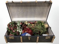 A cane bound vintage trunk containing a quantity of Christmas decorations.