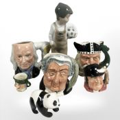 A Nao figure of a child holding a football together with Royal Doulton miniature character jugs