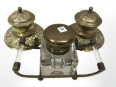 A pair of Victorian brass inkwells together with a further glass inkwell on stand.