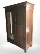 A continental mahogany mirror door wardrobe