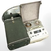 An Art Deco frameless mirror, together with a vintage reel to reel player and a storage box.