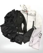 A group of new retail stock clothing including workout wear, Nike items, shorts, a Nike hoodie, etc.