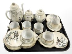 An early 20th century Japanese eggshell tea set, hand painted with geisha figures.