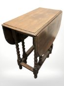 A 1920's oak gate leg table,