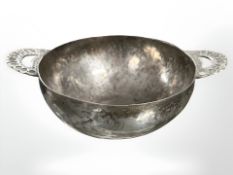 An Arts and Crafts hand forged twin handled silver bowl, diameter 19 cm.
