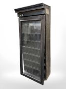 A 19th century glazed pigeon hole cabinet, width 69 cm, height 157 cm.