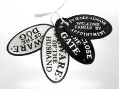 Four cast oval signs.