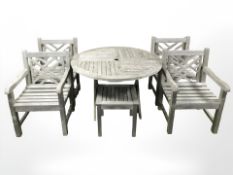 A weathered teak circular garden table, diameter 120 cm,