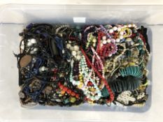 A very large crate containing costume necklaces, beads, costume jewellery.