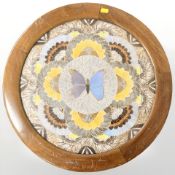 An Edwardian butterfly collage in circular mahogany frame, diameter 54 cm.