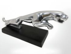 A polished aluminium jaguar figure.