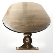 A traditional style oak extending dining room table and six ladder back farmhouse style chairs