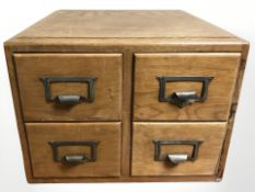 A 1950's beech wood four drawer office chest,