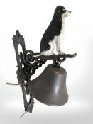 A border collie cast iron bell on bracket.