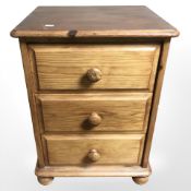 A pine three drawer chest,