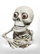 A cast iron skeleton bank.