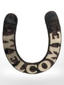 A horseshoe shaped metal plaque.