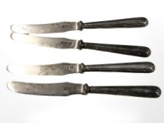 Four silver butter knives together with six silver dessert forks.