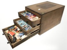 A wooden three drawer bobbin chest containing threads.
