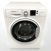 A Hotpoint washing machine, together with operating instructions.