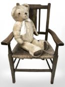 An Edwardian child's chair together with a mohair teddy bear.