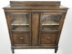 A 1920's oak bookcase, width 123 cm.