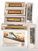 A group of Bachmann HO scale model railway carriages and engines.