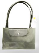 A Longchamp green foldable handbag.
