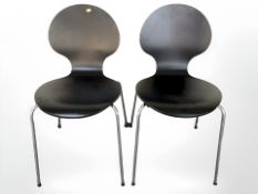 A pair of Scandinavian ply dining chairs on chrome legs.