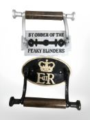 Two reproduction metal toilet roll holders.