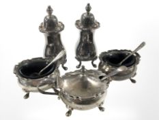 A five piece silver cruet set including pair of salts, pair of peppers and mustard pot.