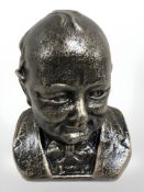 A metal bust of Winston Churchill.