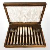 An oak canteen of silver plated fish cutlery.
