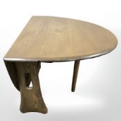 An Ercol elm small drop leaf table,