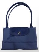 A Longchamp cornflower blue foldable handbag.