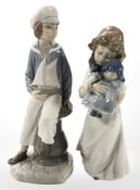 A Lladro figure modelled as a boy with a sailing boat, height 23.
