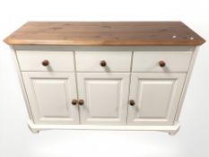 A pine painted sideboard fitted with three drawers, width 134 cm.