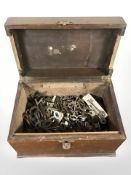 A wooden box containing a quantity of antique and later keys.