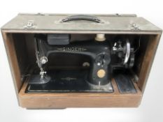 A Singer sewing machine in case.