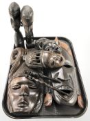 A group of carved hardwood African masks and figures.
