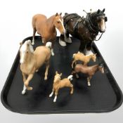 A group of horse figures by Beswick, cantering horse, three foals.