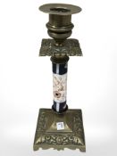 A Victorian brass candlestick with porcelain column, height 22 cm.
