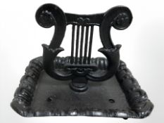 A Victorian style lyre boot scraper