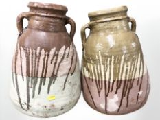 Two large part-glazed olive jars, height 40 cm.