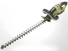 A Ryobi electric hedge trimmer with battery.