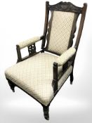 A non-matching pair of Edwardian oak salon armchairs