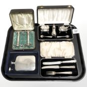 A three piece silver plated condiment set, cased, together with a pair of antique knife rests,