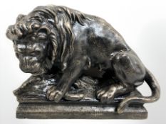 A cast iron lion and boar figure on plinth.