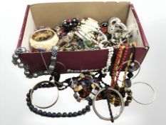 A box containing a large quantity of beads, costume jewellery and trinkets.